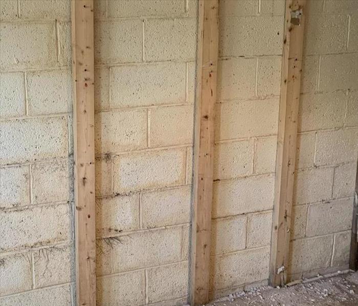 concrete wall with 3 wood post 