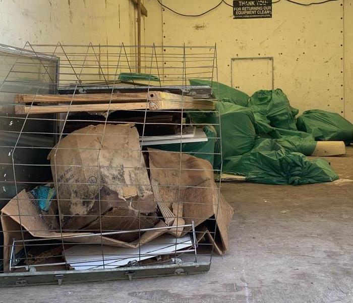 A semi-empty box trucks with bagged and loose debris 